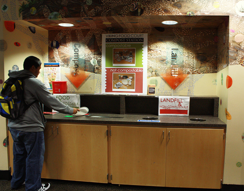 A PSU student sorts his food waste in the Viking Food Court.