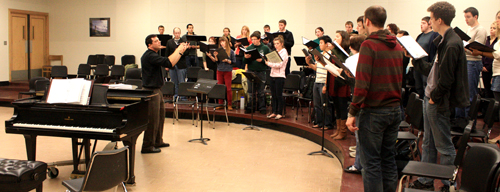 In sync: Ethan Sperry, far left, conducts the PSU Chamber Choir during rehearsals for its concert, Shattered Faith.