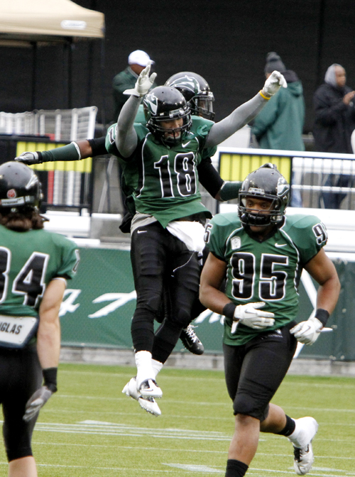 Homestand: Viking senior receiver Ricky Cookman (#18) leaps in celebration with sophomore defensive tackle Julius Moore (#95), while junior tight end Greylin James (#80) acknowleges the support of the Portland State fans in attendance.