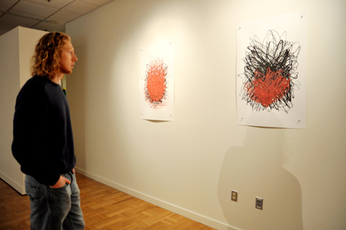 Explosive art: PSU student Andy Kaempf savors the sight of artist Jim Neidhardt’s piece, titled “Atomic Fireballs,” in the Littman Gallery’s geology-based exhibition.