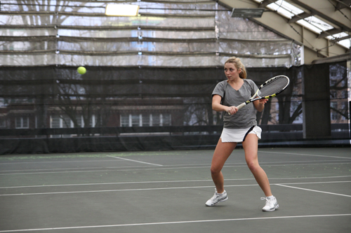 Eyes on the ball: Freshman Megan Govi hones her backhand on the practice court. Govi, one of the best players last week, will have to be on top of her game this weekend.