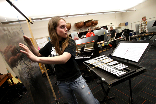Kelsey Preslar plays one of the six “Thunder Sheets” present for the piece.